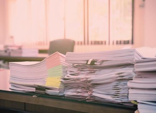 Paper files on a desk on a desk