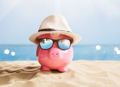 Retire in Style Piggy bank with sunglasses & hat chillaxing  on the beach