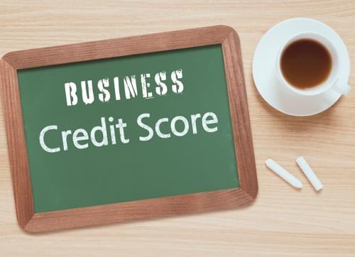 business credit score on blackboard with chalk and black coffee 