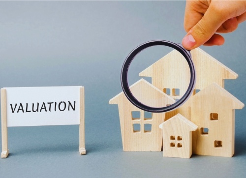 valuation sign and magnifying glass timber block houses 