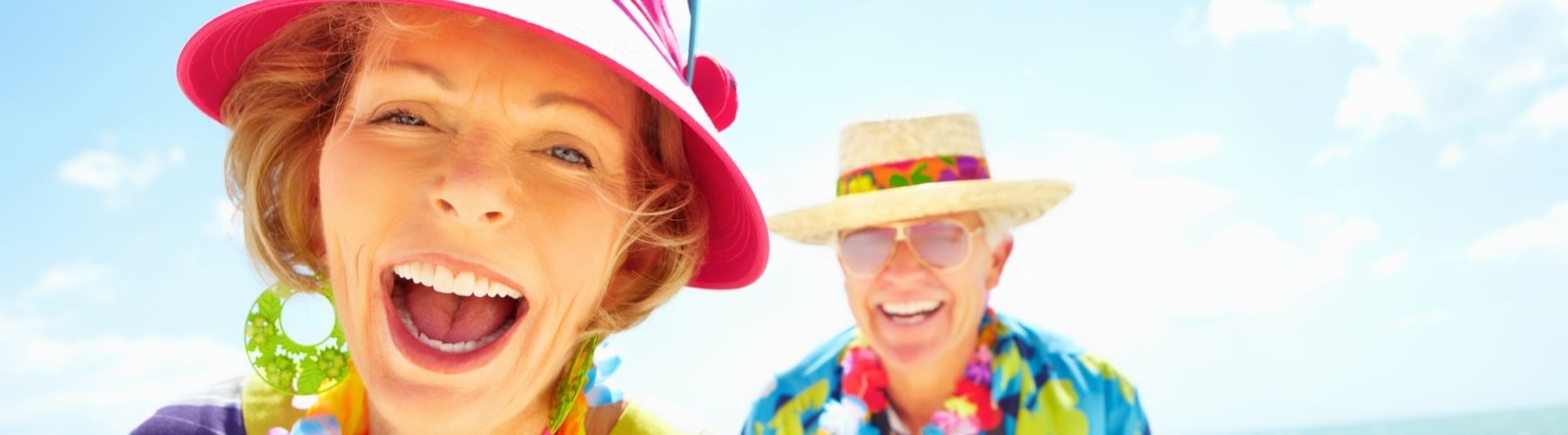 Centrelink - retired elderly couple happy and wearing tropical clothing