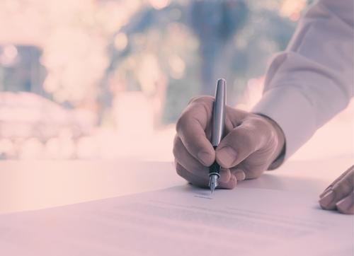 Man signing agent ATO nomination form, pink aesthetic