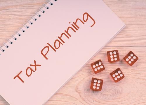 Tax Planning Written On Paper With Dice Beside It