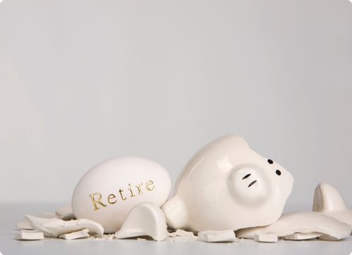 Broken white piggy bank with a white egg that says retire in gold writing