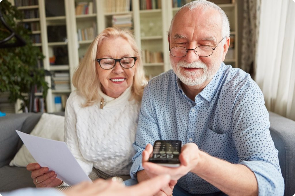 Senior couple reviewing superannuation documents with their financial advisor.