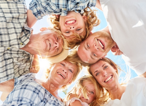 Extended family in a circle looking down